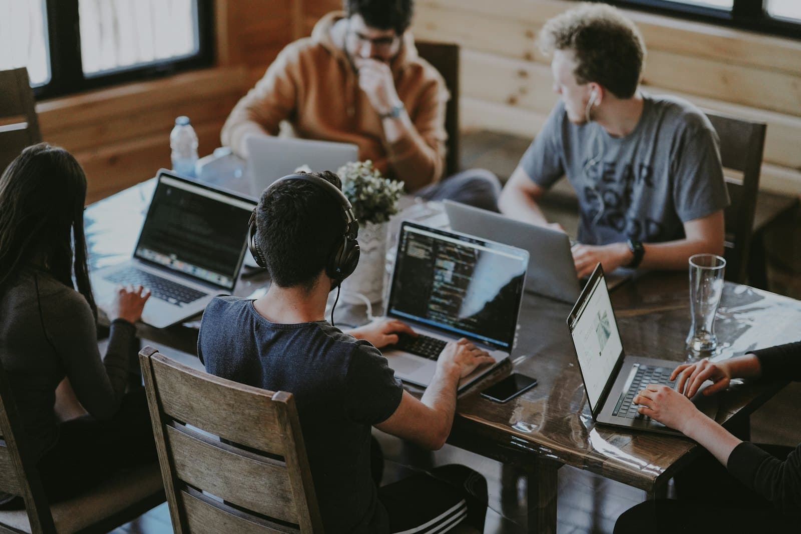 An engineering team working together on laptops