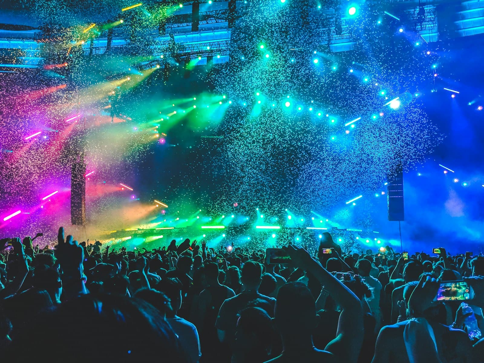 A crowd facing an illuminated concert stage
