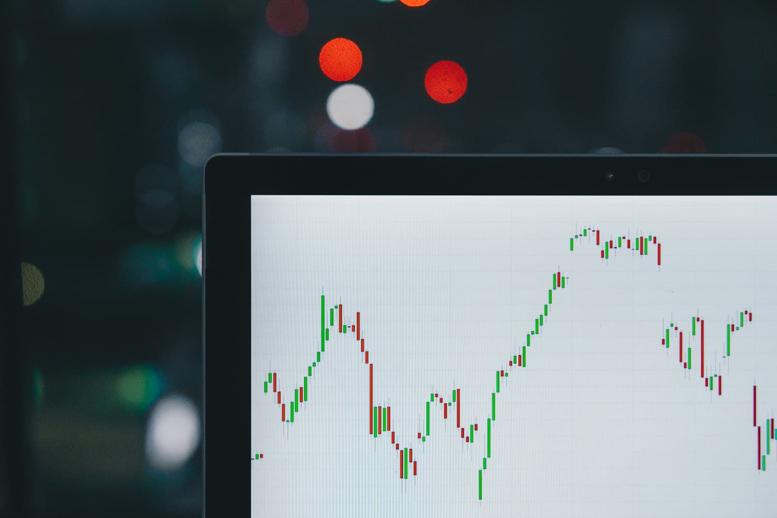 A candlestick price chart on a laptop screen